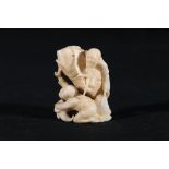 A carved ivory netsuke of Ebisu riding a giant carp, a man below him holding a fish basket, 5cm,