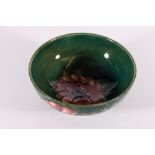 Moorcroft bowl decorated with anemone pattern on a rich green ground, WM signature to base, 16.5cm