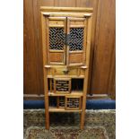 Antique Chinese soft wood chicken coup cabinet of typical form with pierced doors raised on square