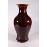 A large 19th century Chinese flambé glazed baluster vase with deep red glaze and flaring to a