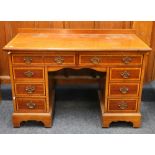 Antique mahogany and inlaid kneehole pedestal desk, the rectangular top with raised gallery and