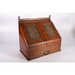 Late Victorian carved oak sloped-fronted table-top stationary box with envelope rack, pen tray,