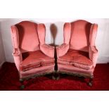 Pair of Victorian mahogany wing back armchairs with carved and shaped skirt raised on cabriole