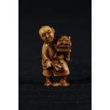 Ivory netsuke of a man with an articulated head, holding a dragon mask, 42mm, 48cm, unsigned Meiji/