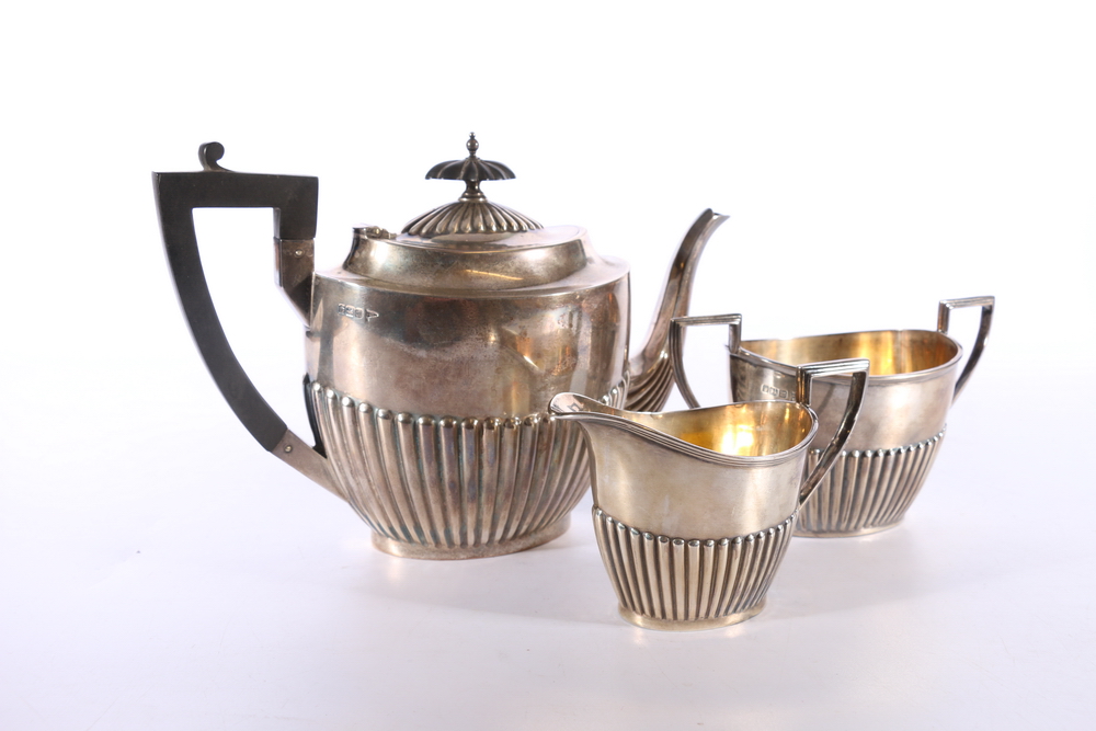 George V silver three piece tea set of half gardooned design by Walker and Hall, Sheffield 1913