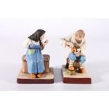 Pair of Russian Gardner style bisque porcelain figures of bast shoe maker and a female seated, red