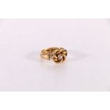 18ct gold knot ring set with central diamond approximately 0.15ct, ring shank internal engraved "