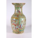 A 19th century Chinese Canton famille rose baluster vase, the celadon ground decorated with panels