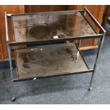 Mid 20th century modern design chromed metal and smoked glass two tier trolley in the manner of