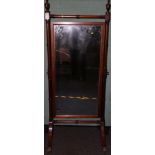 Regency style mahogany cheval mirror mounted by urn finials and ring turned frame enclosing