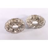 Pair of Edwardian silver dishes with flowerhead pattern centre and pierced rims by Walker and Hall