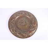 An Arts & Crafts Newlyn School repousse copper charger decorated to the centre with galleon