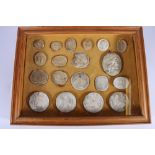 Grand Tour, a case of nineteen Romanesque intaglio plaster impression roundels, the largest 8cm x