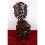 Gothic revival heavily carved oak panel back hall chair raised on hoof supports with lion head to