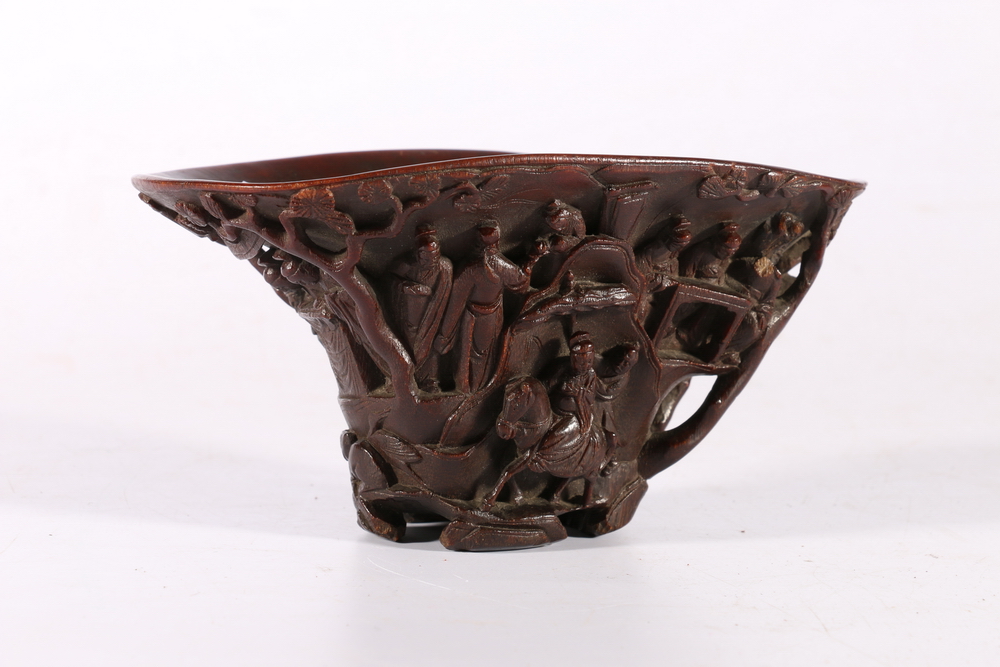 19th century Chinese carved rhinocerous horn libation cup carved to the exterior with figures on