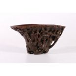 19th century Chinese carved rhinocerous horn libation cup carved to the exterior with figures on