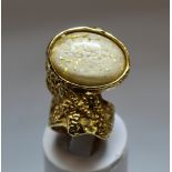 Yves Saint Laurent "Arty" cocktail ring in gilt metal with mottled white and gold oval cabochon,