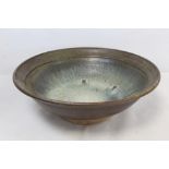 20th century large studio pottery bowl of circular footed form with brown, white and blue drip