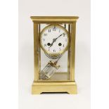 French four glass mantel clock with mercury pendulum in gilt brass, 25.5cm.
