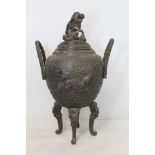 Chinese Qing dynasty patinated bronze censer vase of twin handled ovoid form on four dragon mask