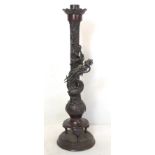 Late 19th/early 20th century Oriental lacquered bronze candlestick with lobed drip tray, the