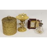 Looping alarm timepiece with travelling case, scent spray and two gilt metal items.