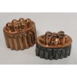 Antique copper and tin jelly mould of reeded oval form, the top with castellated stylised bow,