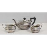 Silver three-piece tea set of panelled boat shape, Birmingham & Chester, 1915. 16oz.