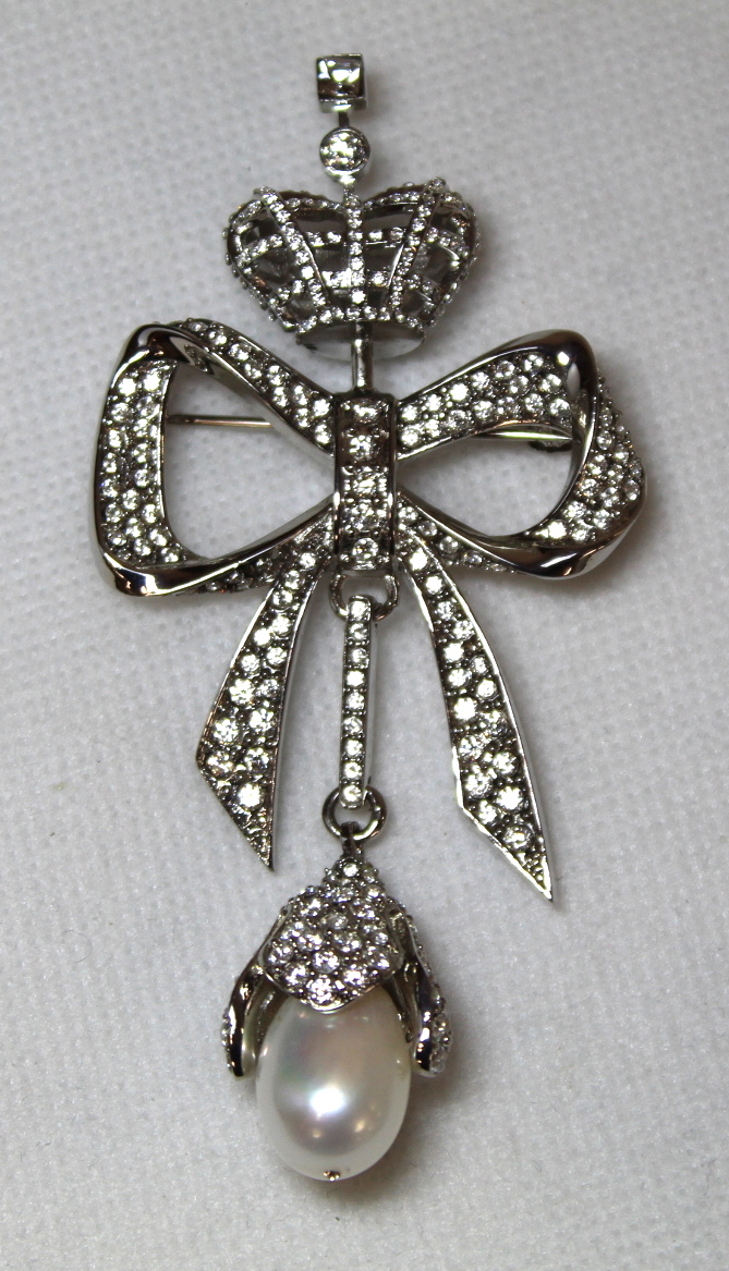 Balenciaga bow and crown white crystal and Mother of Pearl brooch, 9cm long. Boxed with jewellery