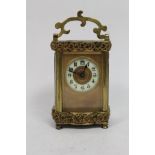 Late 19th century miniature carriage clock with sunken enamel dial. Gilded foliate borders with