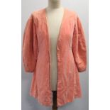 Early 20th century lady's salmon pink velvet jacket of flared form with fitted waist and panelled