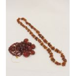Amber fragment and gilt bead necklace, 52g gross, and another, faceted.