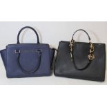 Two Michael Kors handbags, one navy, 28cm wide, the other black with black and gilt metal chain