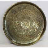 Indian circular heavy brass tray with incised decoration of deities and animals amongst flowers