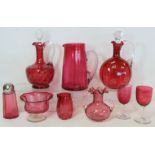 Small collection of Victorian cranberry glass, comprising: two claret jugs; large tapered jug; sugar