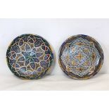 Two North African pottery shallow circular dishes or wall plaques with polychrome Moorish