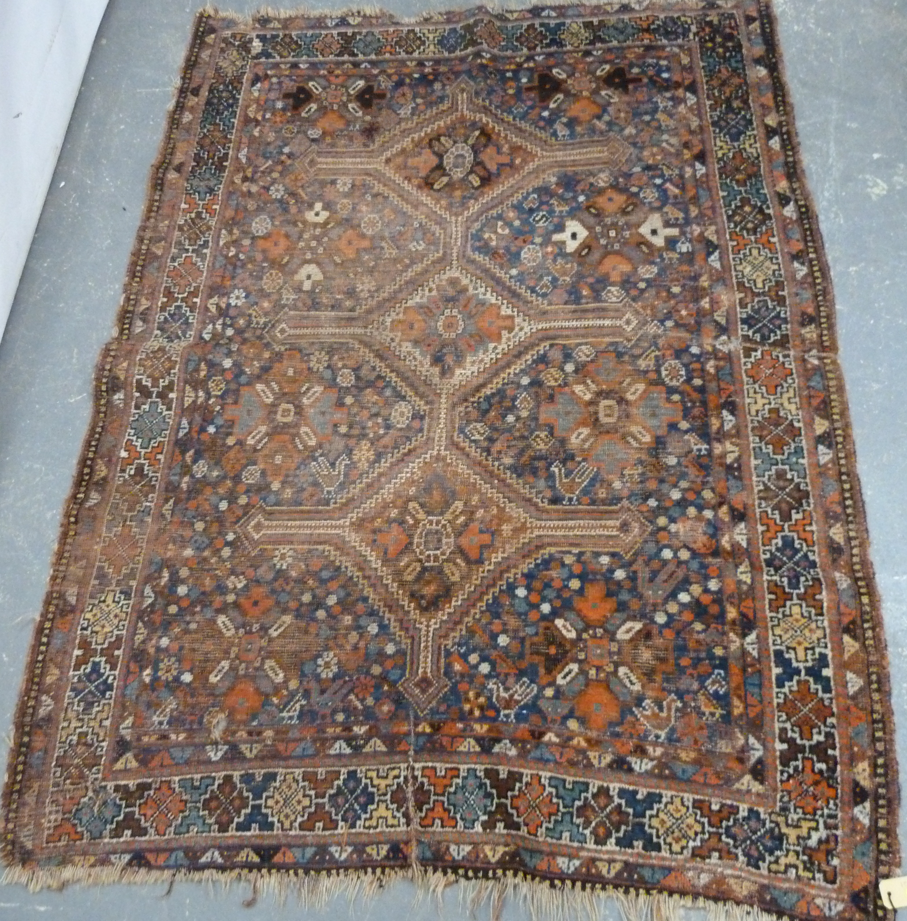 Persian wool rug with central triple diamond lozenge, some wear, 175cm x 130cm.