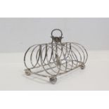 Silver toast rack with arched wires, for six, by W Fountain, 1828. 6oz.