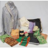 Box containing a quantity of various silk and other remnants, sari fabric made into a shawl, a large