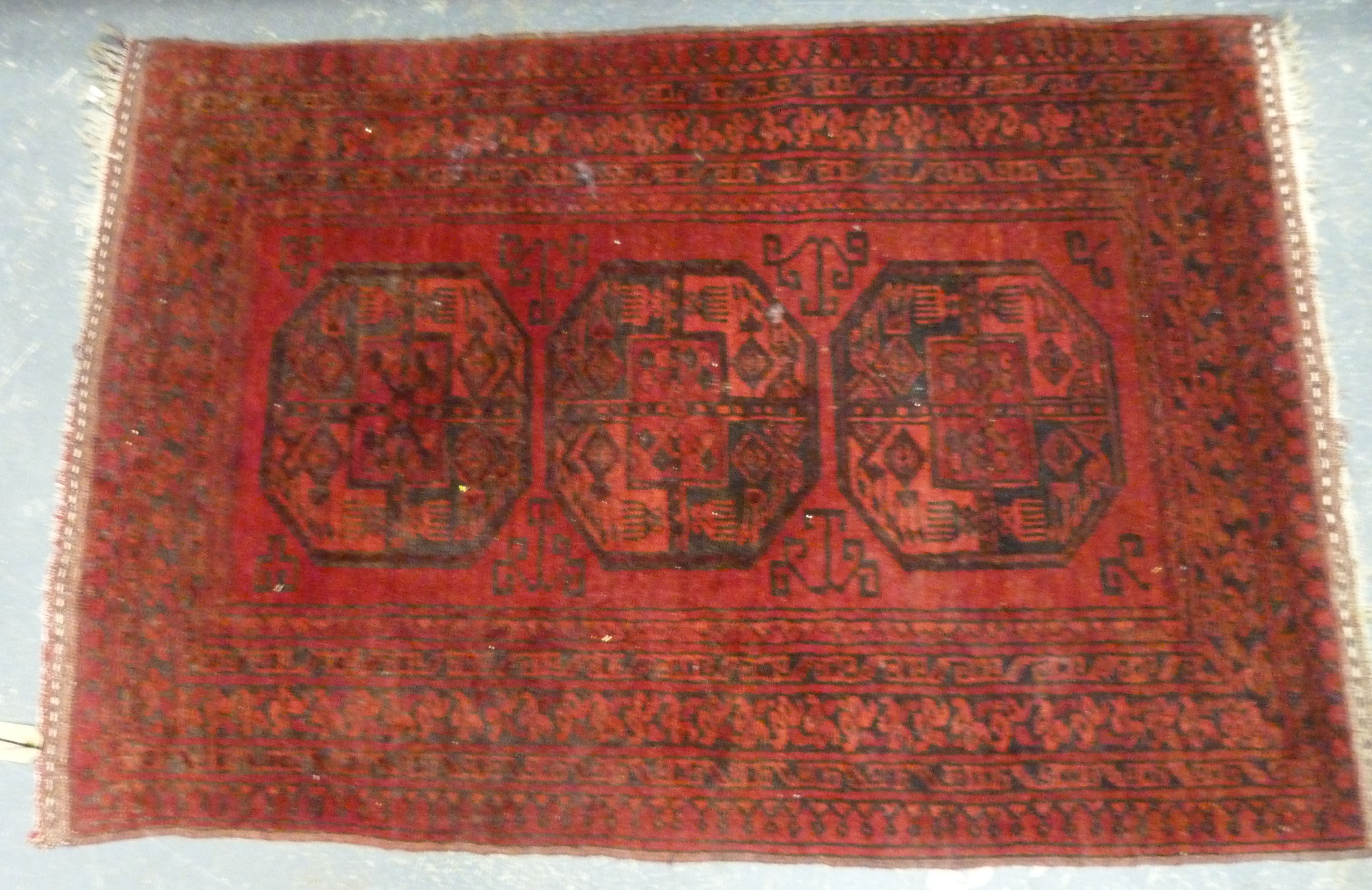 Small Persian red and black prayer mat with three octagon medallion, 125cm x 86cm.