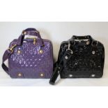 Two Jaeger "Tilly" lady's patent leather handbags: one in grape and one in black. Both with