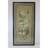 20th century Chinese embroidered silk panel depicting a herd of cranes in a landscape with four