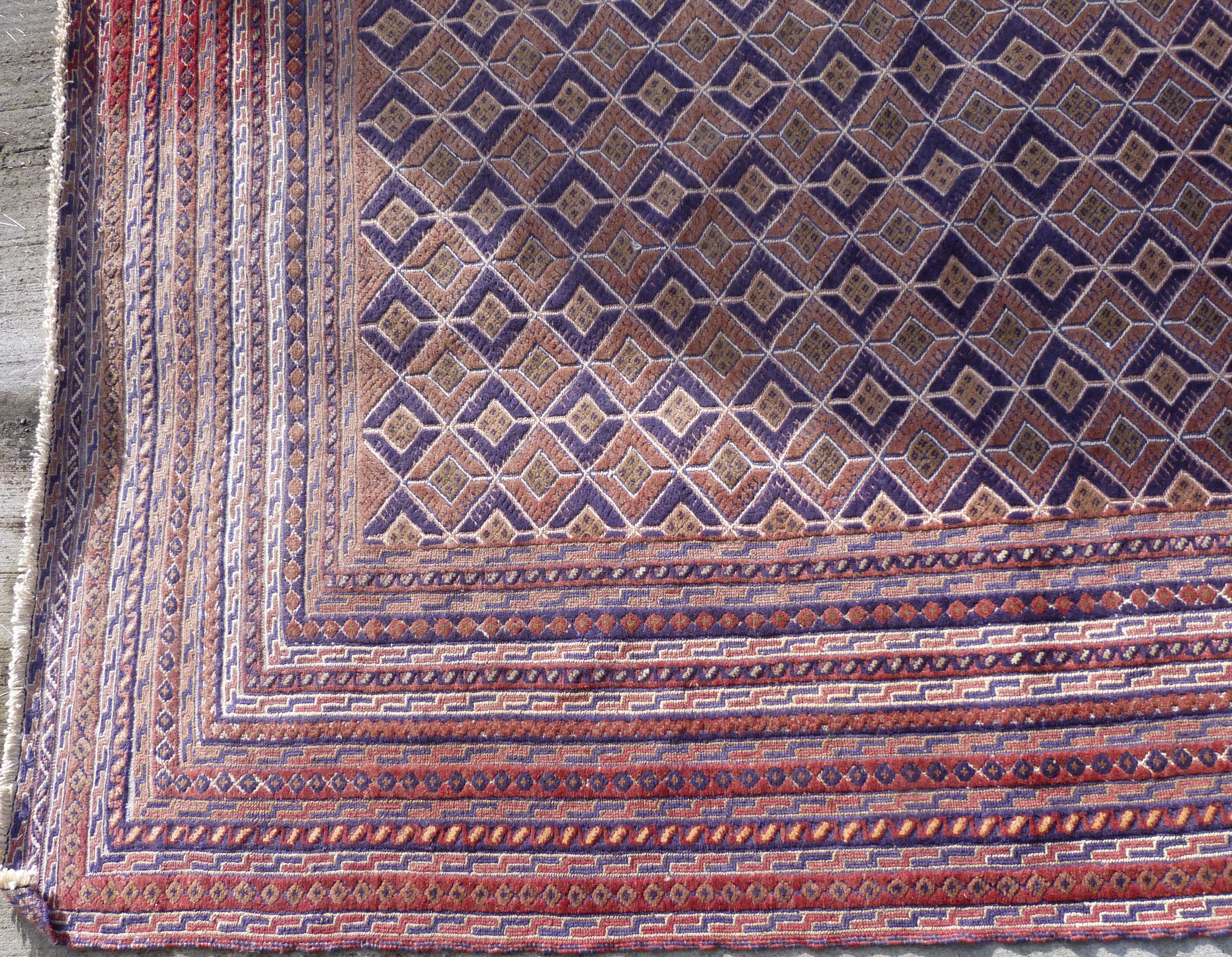 Afghan Mushwani wool carpet with diamond lattice field, in red, blue and ochre, 271cm x 203cm. - Image 2 of 4