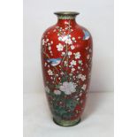 Late 19th/early 20th century Japanese cloisonne vase of ovoid form, the red ground decorated with