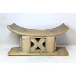 African tribal carved pale wood headrest, the rectangular dished top on rectangular supports with