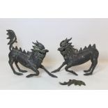 Pair of Chinese bronze figures of Kylin, 20cm high, one with detached tail.