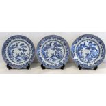 Set of three 18th century Chinese blue and white circular plates depicting a lake scene with boy