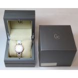 G. C. Guess Collection two-eye day/date lady's wristwatch with mother of pearl dial, white bezel and