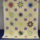 Early to mid 20th century pieced block quilt with multiple flowerhead motifs in polychrome