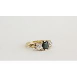 Yellow metal ring set with tourmaline flanked by two diamonds Size O